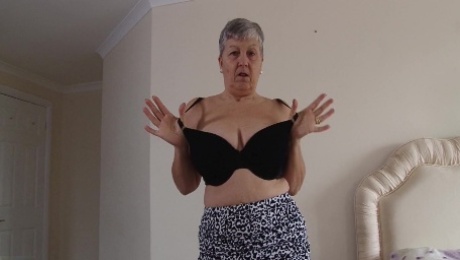 Short haired mature amateur British granny Savana strips at home